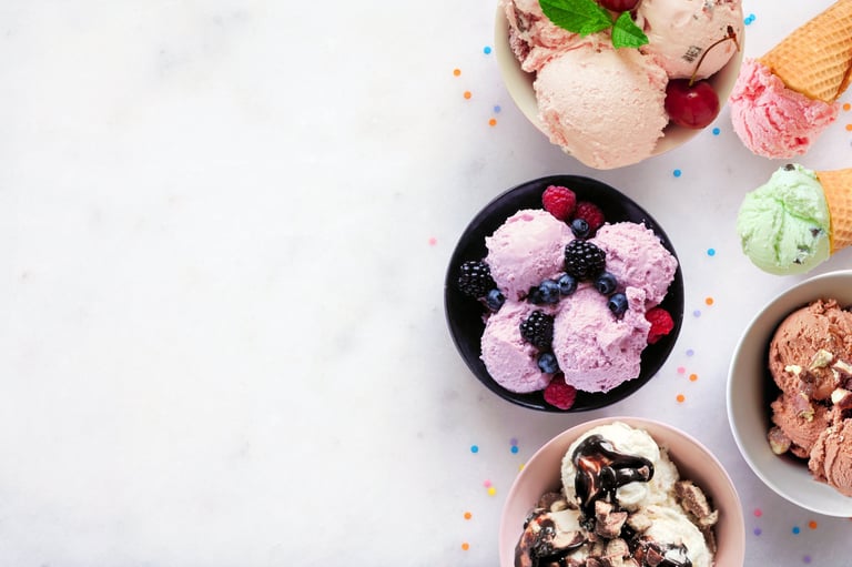 Colorful ice cream bowls with fresh fruit toppings showing delicious frozen yogurt or gelato
